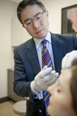 Wang consulting with his colleagues.