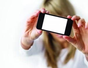 http://www.dreamstime.com/royalty-free-stock-photos-woman-showing-mobile-phone-empty-display-out-focus-image37662098